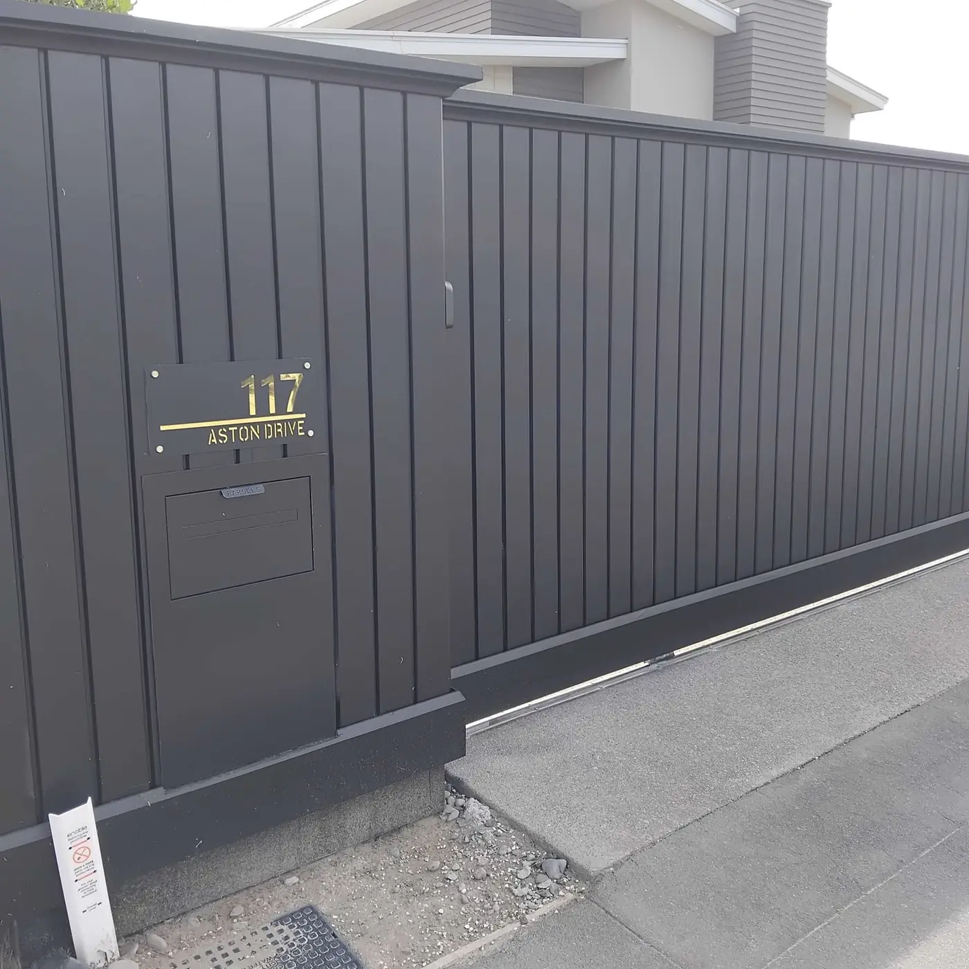 Finished black shiplapped paling fence with capping, scotia and kickboard
