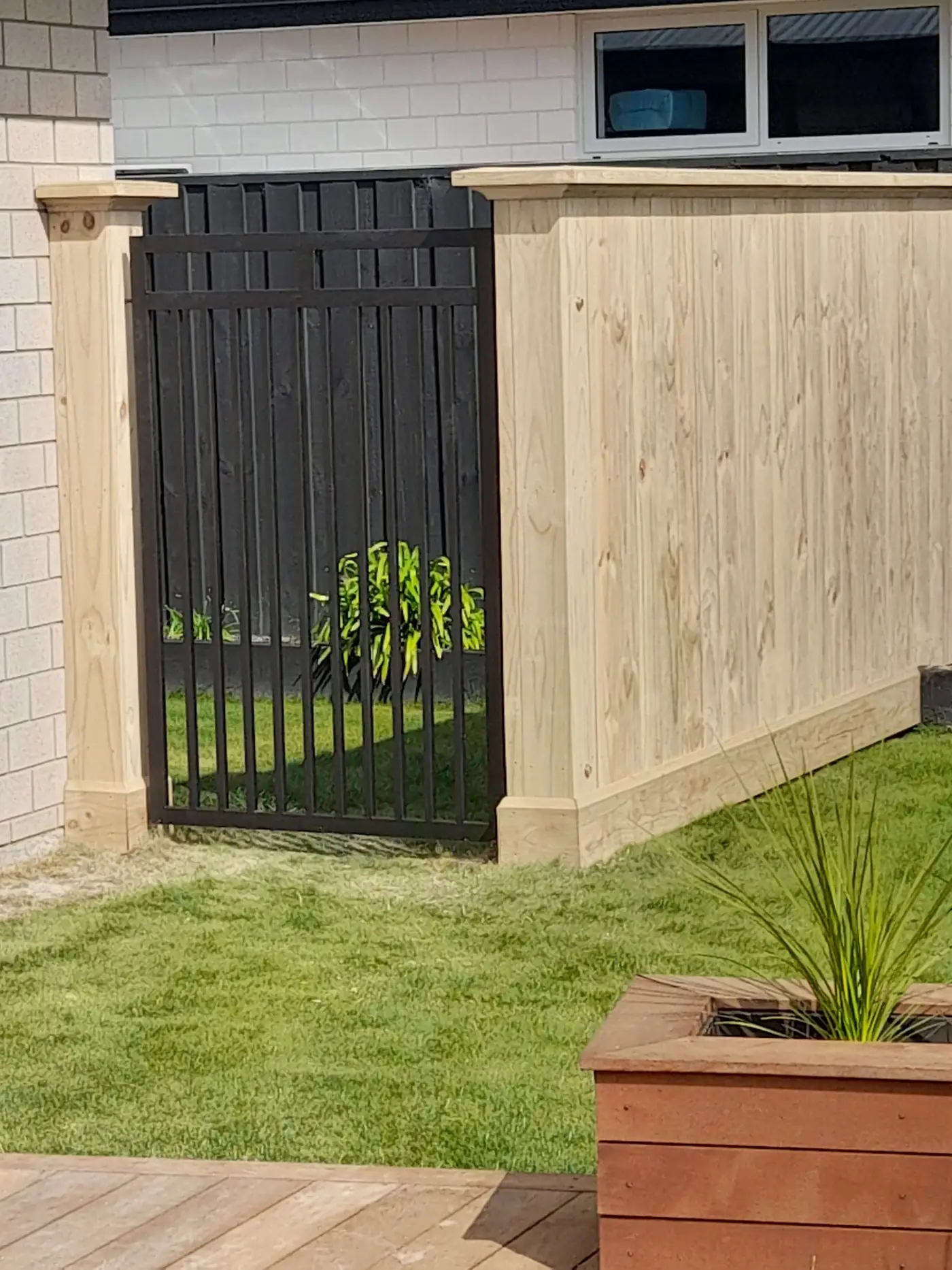 Timber fence with black metal gate, Addington, Christchurch